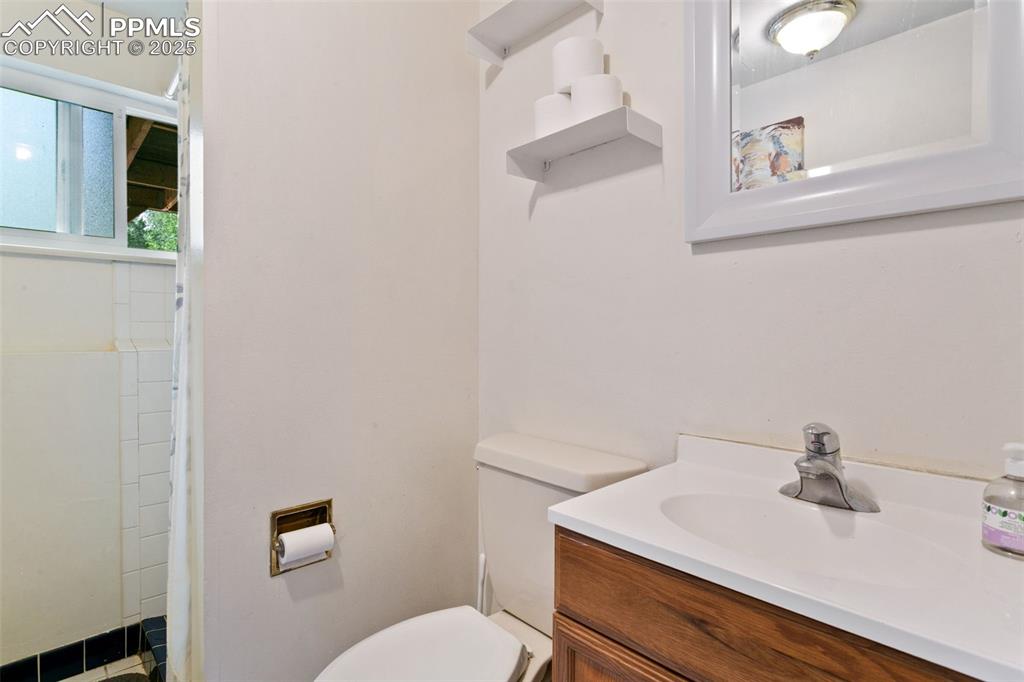 Image 17 of 28: Full bath with vanity and toilet