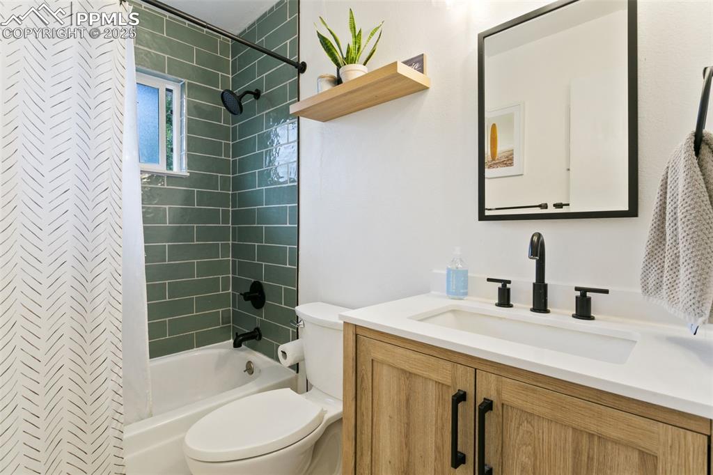 Image 25 of 28: Full bathroom featuring vanity and shower / bath combo