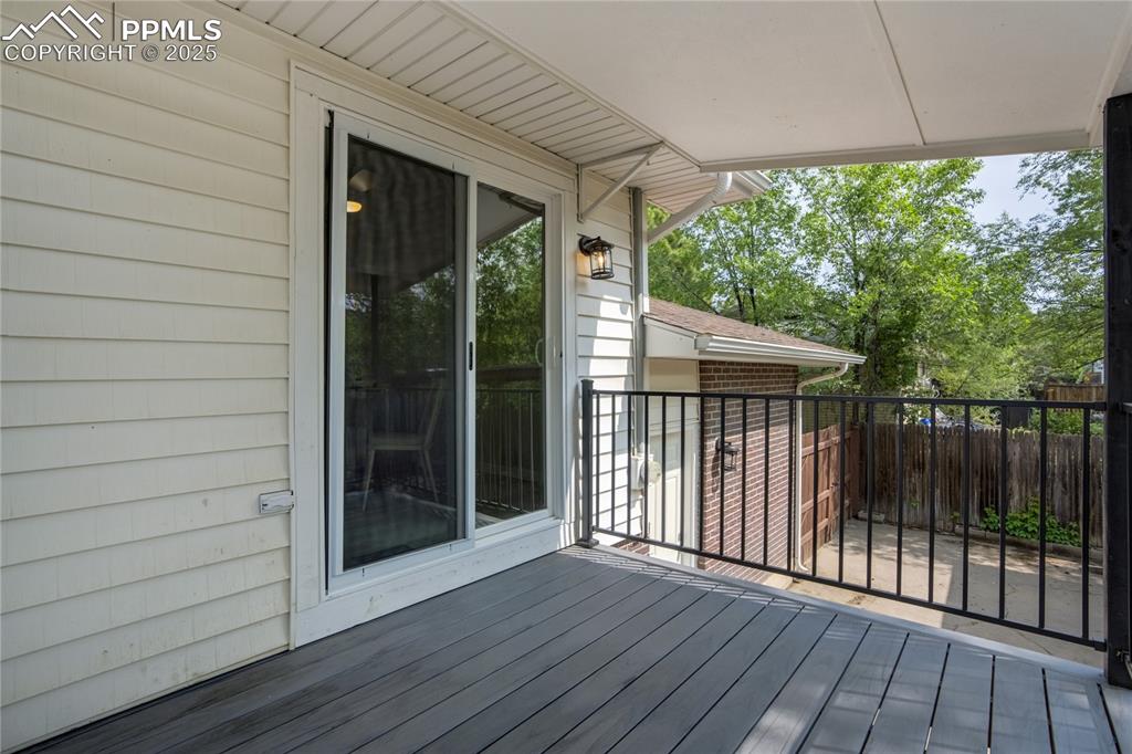 Image 10 of 41: Covered Composite Deck off Kitchen - New Flooring!