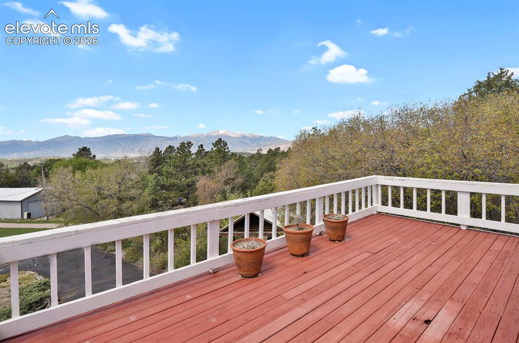 Image 14 of 37: Panoramic views of Pikes  Peak from this living room deck off the front