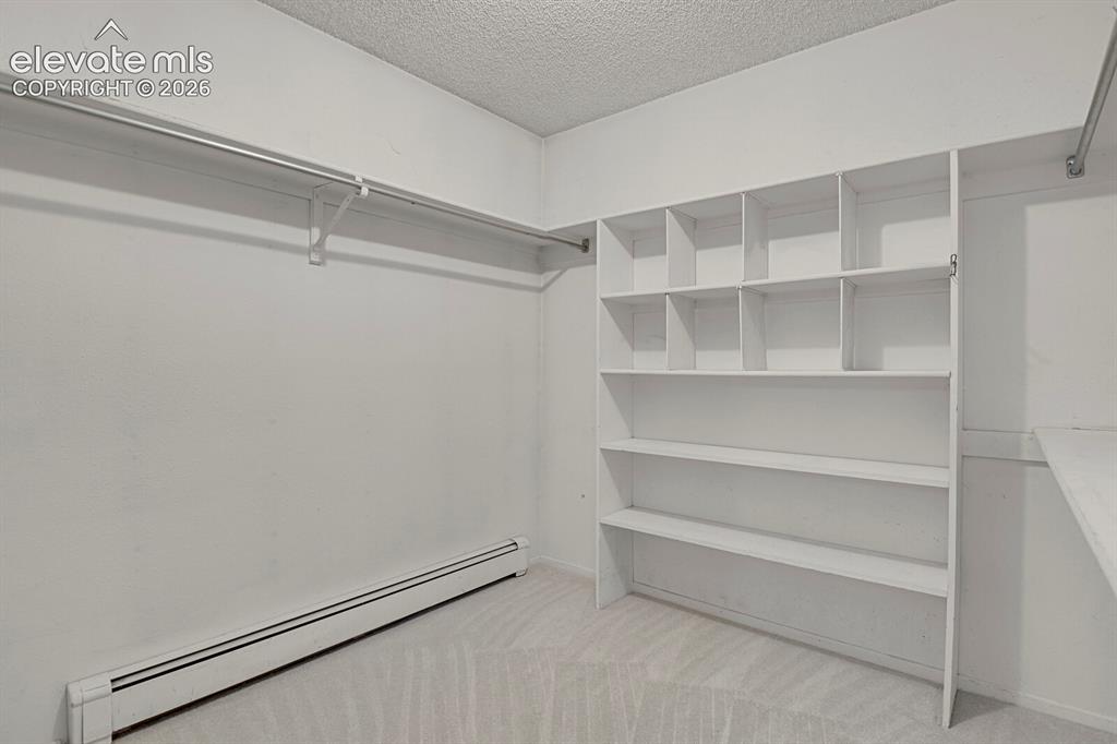 Image 20 of 37: Primary walk in closet-upper