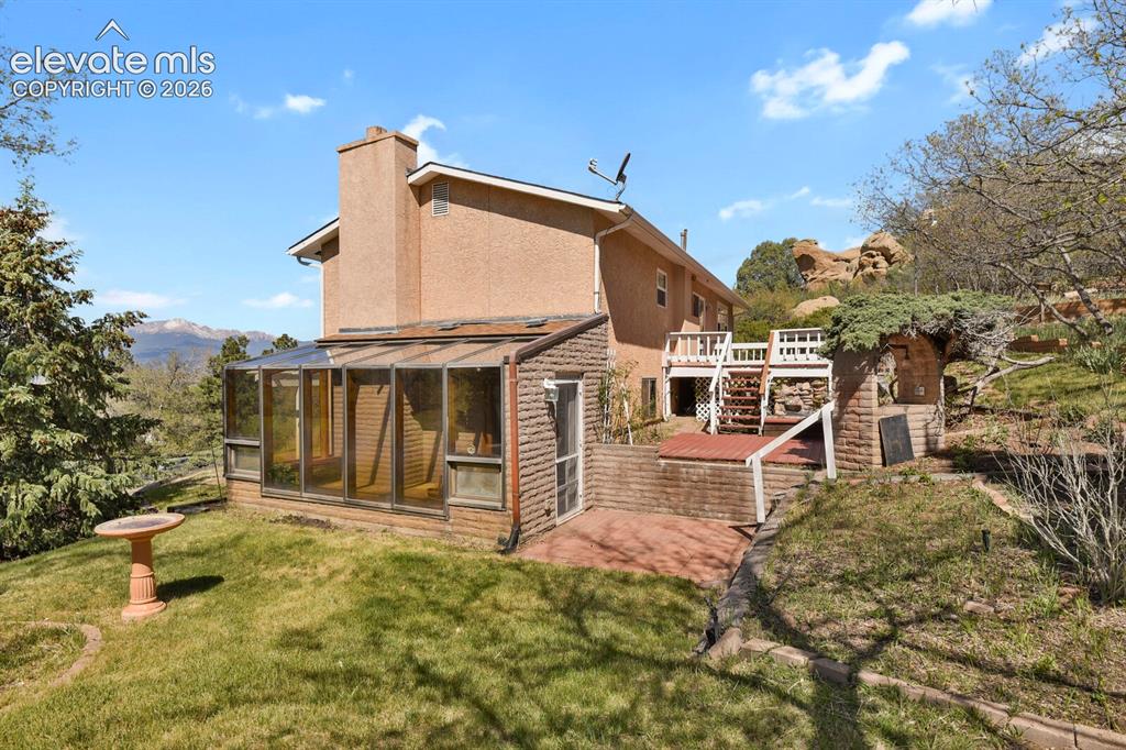 Image 24 of 37: with sun room & 3 patios/decks in the back
