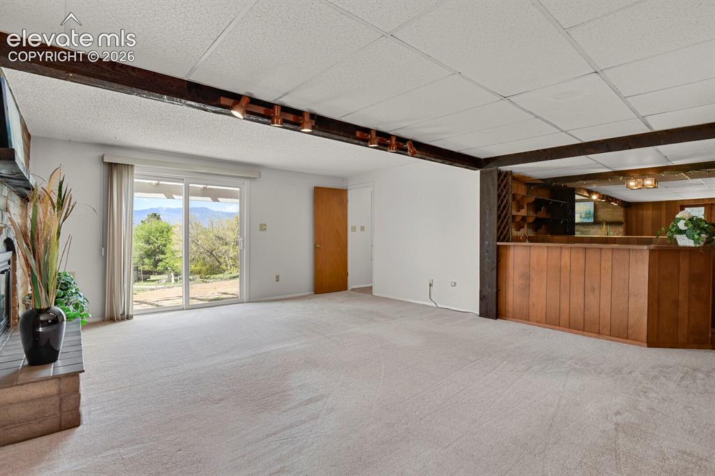 Image 6 of 37: with wet bar & walk out to the front