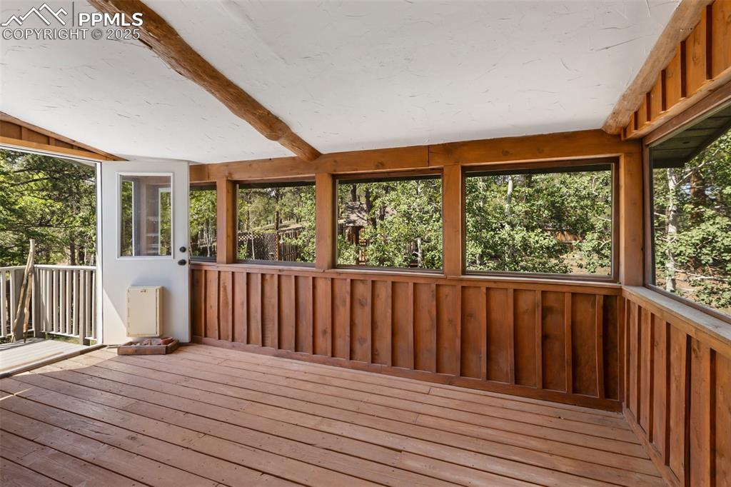Image 15 of 48: Screened space on main level accessing the back yard.