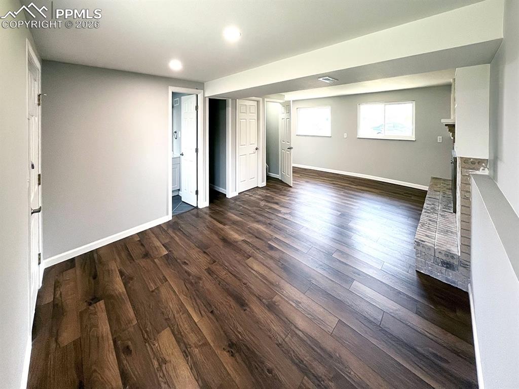Image 10 of 23: Lower level Family room with wood burning fireplace