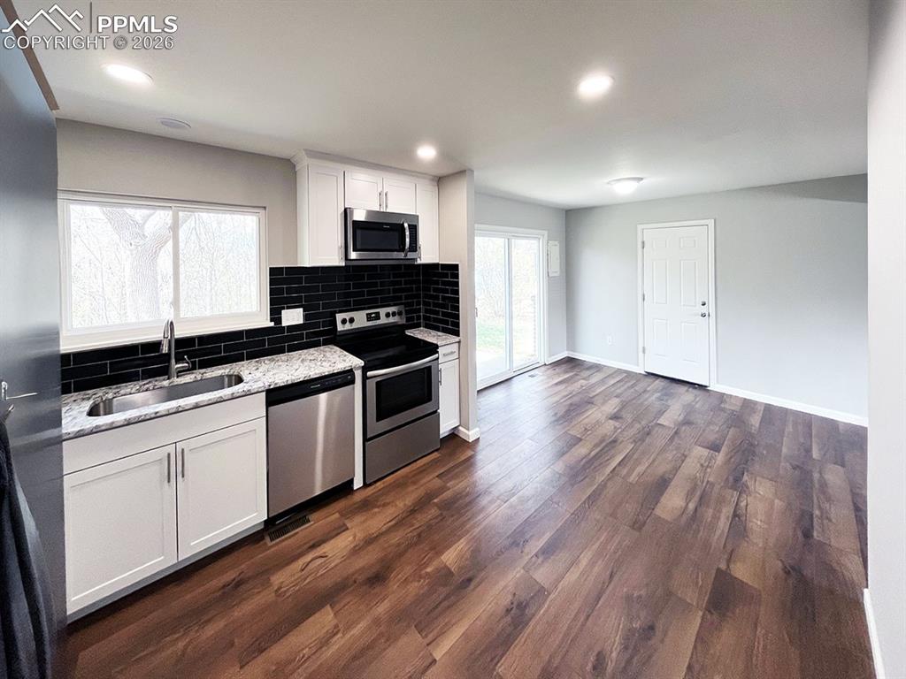 Image 4 of 23: Kitchen opening up to the dining area