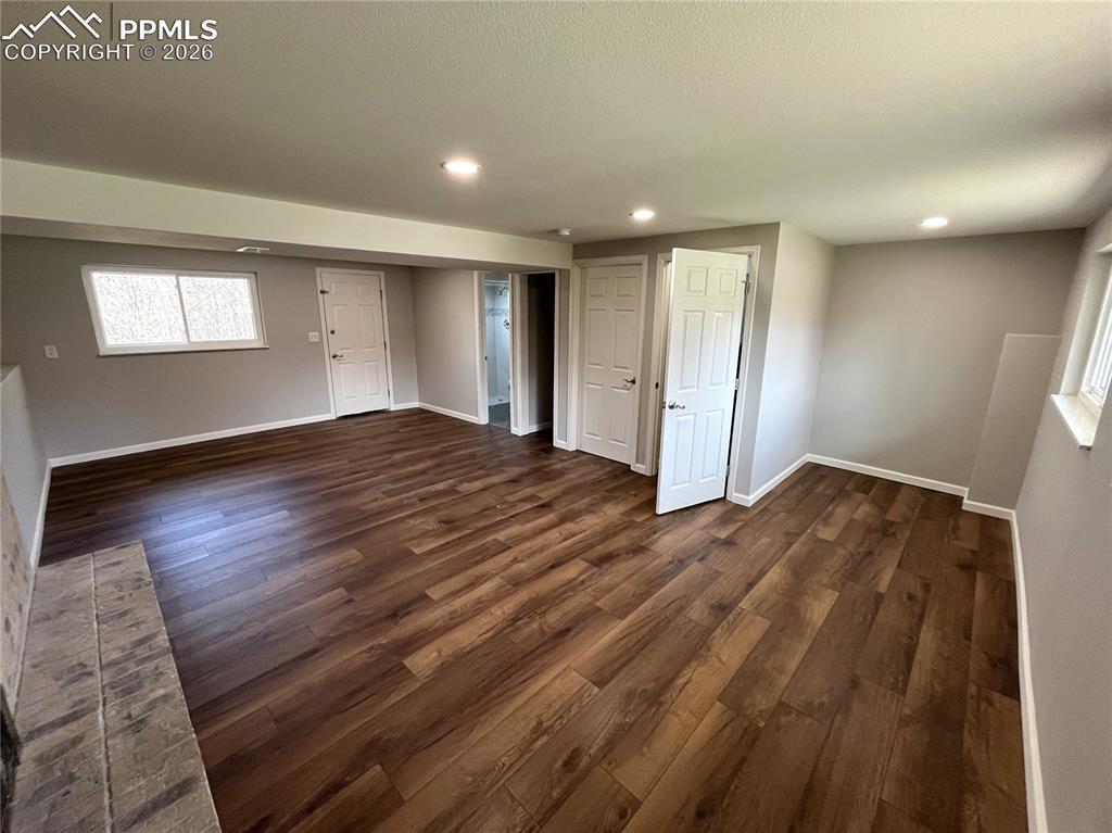 Image 9 of 23: Lower level Family room with wood burning fireplace