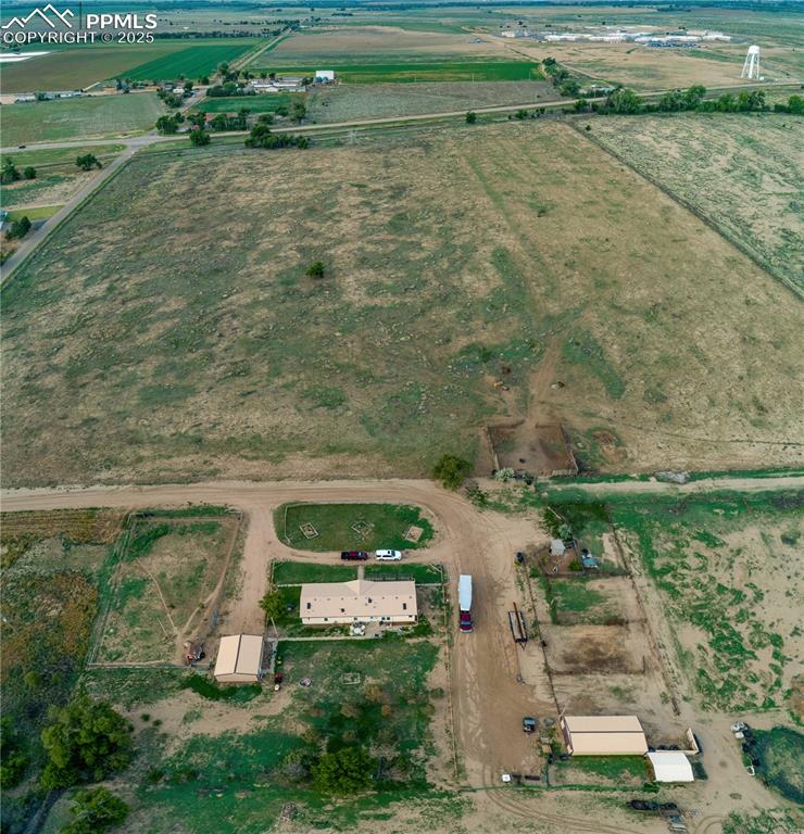 Image 12 of 50: View of property location featuring rural landscape and rows of crops