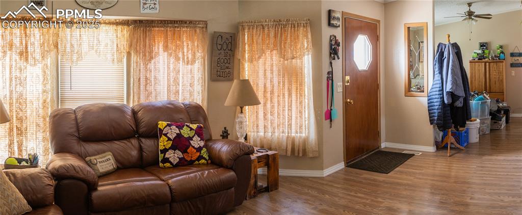 Image 27 of 50: Living room with a ceiling fan and wood finished floors