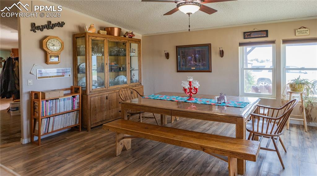Image 33 of 50: Dining area featuring ornamental molding, a textured ceiling, ceiling fan,