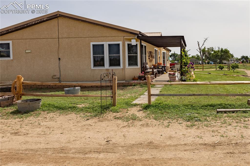 Image 38 of 50: View of property exterior with a patio and a yard