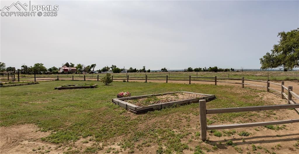 Image 42 of 50: View of yard featuring a view of rural / pastoral area and a vegetable gard