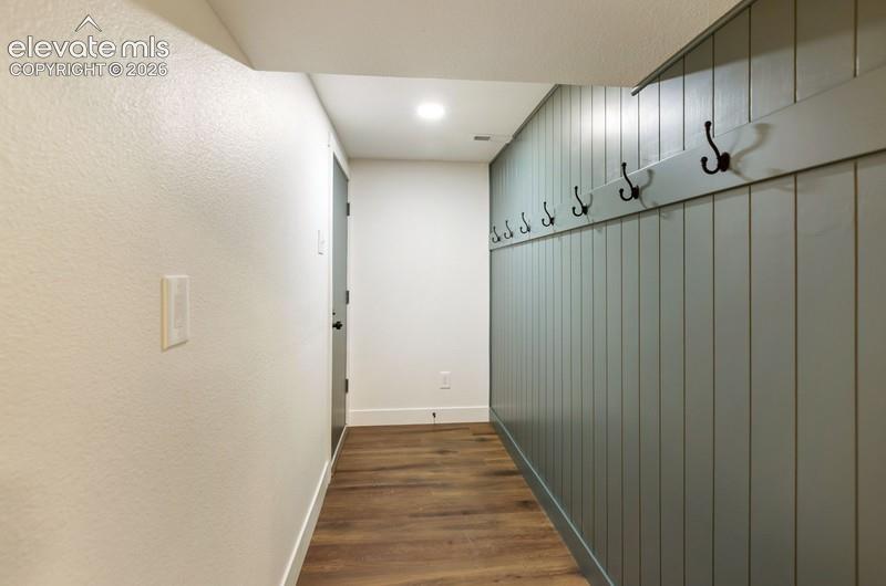 Image 23 of 26: Coat racks and entry from garage. 