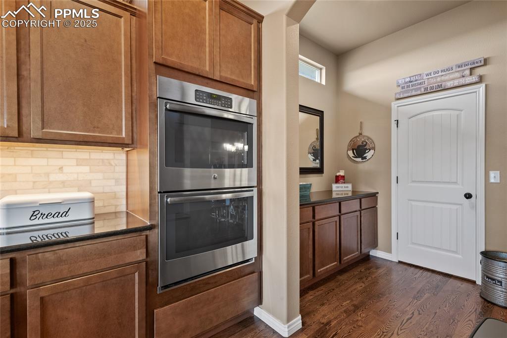 Image 19 of 49: Double ovens, leading to coffee bar toward the pantry then into the dining