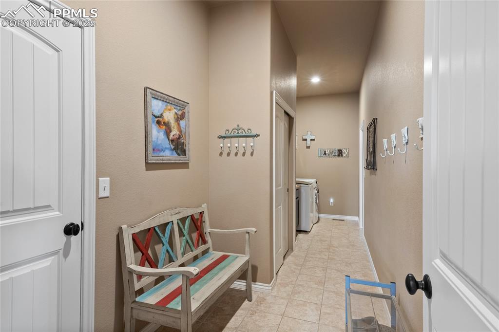 Image 31 of 49: Laundry room/mudroom with entryway from the garage. Private from the rest o