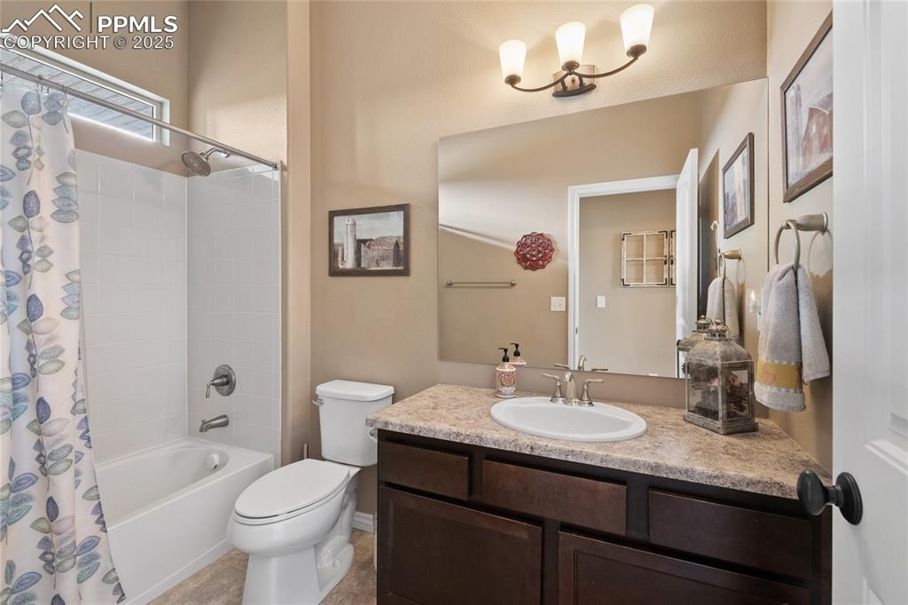 Image 35 of 49: Main level full bath serves bedrooms 2 and 3.