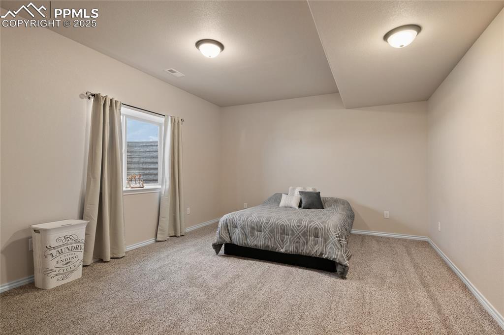 Image 43 of 49: Lower level secondary suite with ensuite bath.(Bedroom #6.)