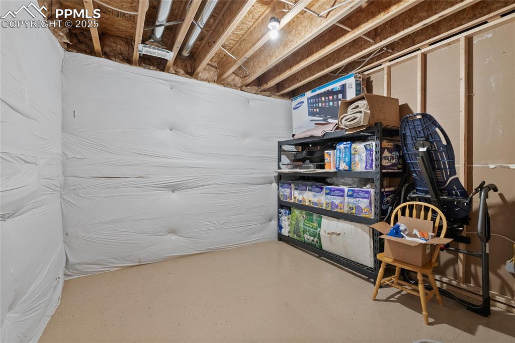 Image 46 of 49: 2nd storage room off of lower level bar area with epoxy surface floors and