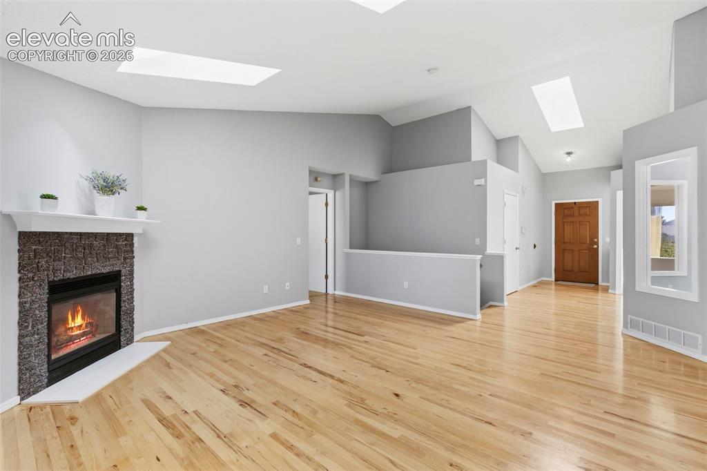 Image 10 of 50: Gas fireplace & wood floors!