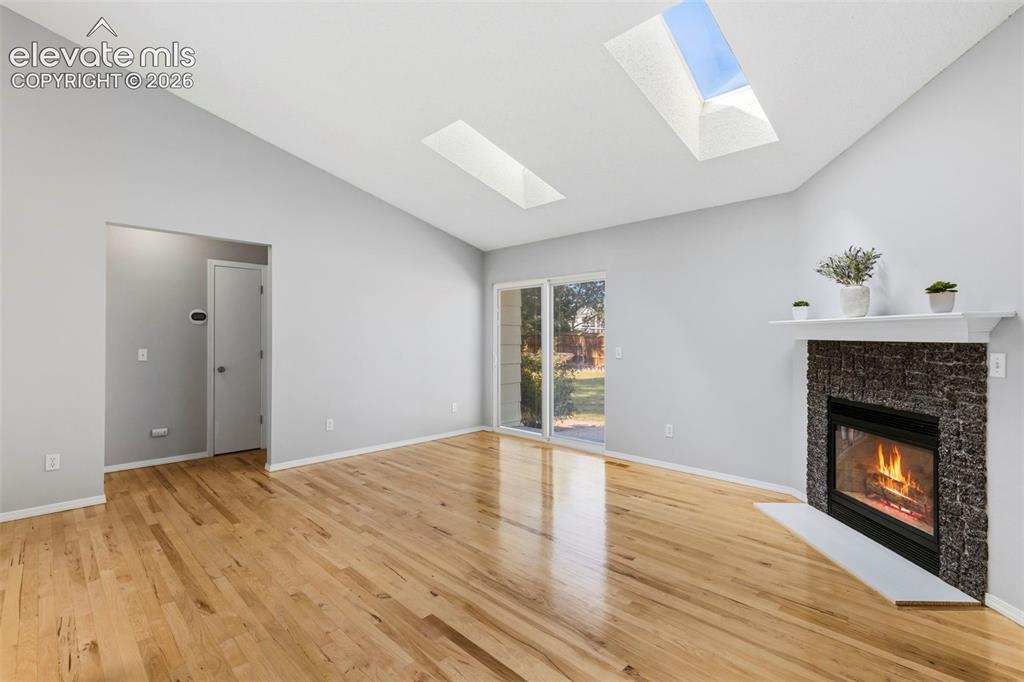 Image 12 of 50: Fireplace and a walk-out to the huge back yard!