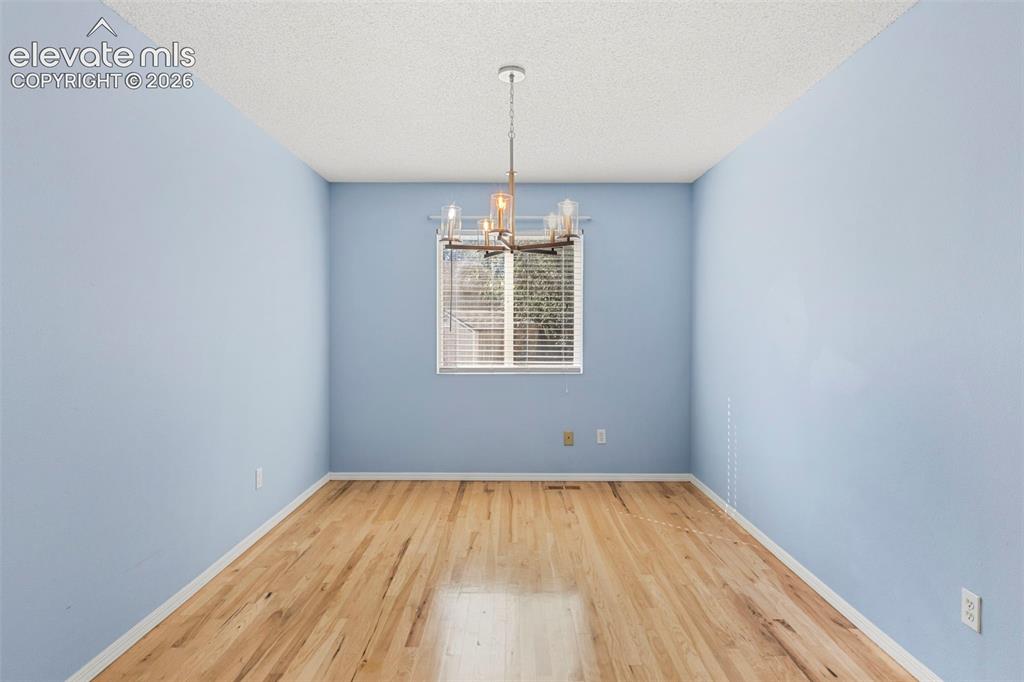 Image 19 of 50: Separate dining room w/ updated light fixture
