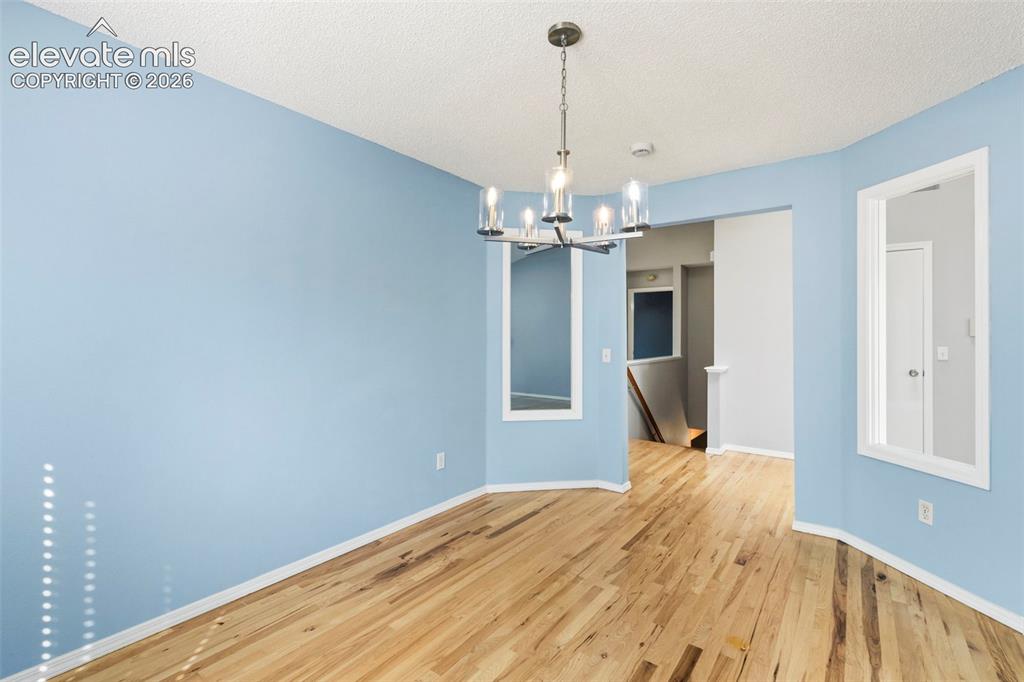 Image 20 of 50: Separate dining room w/ updated light fixture