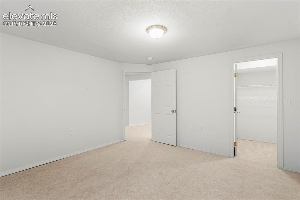 Image 32 of 50: Large basement bedroom w/ walk-in closet