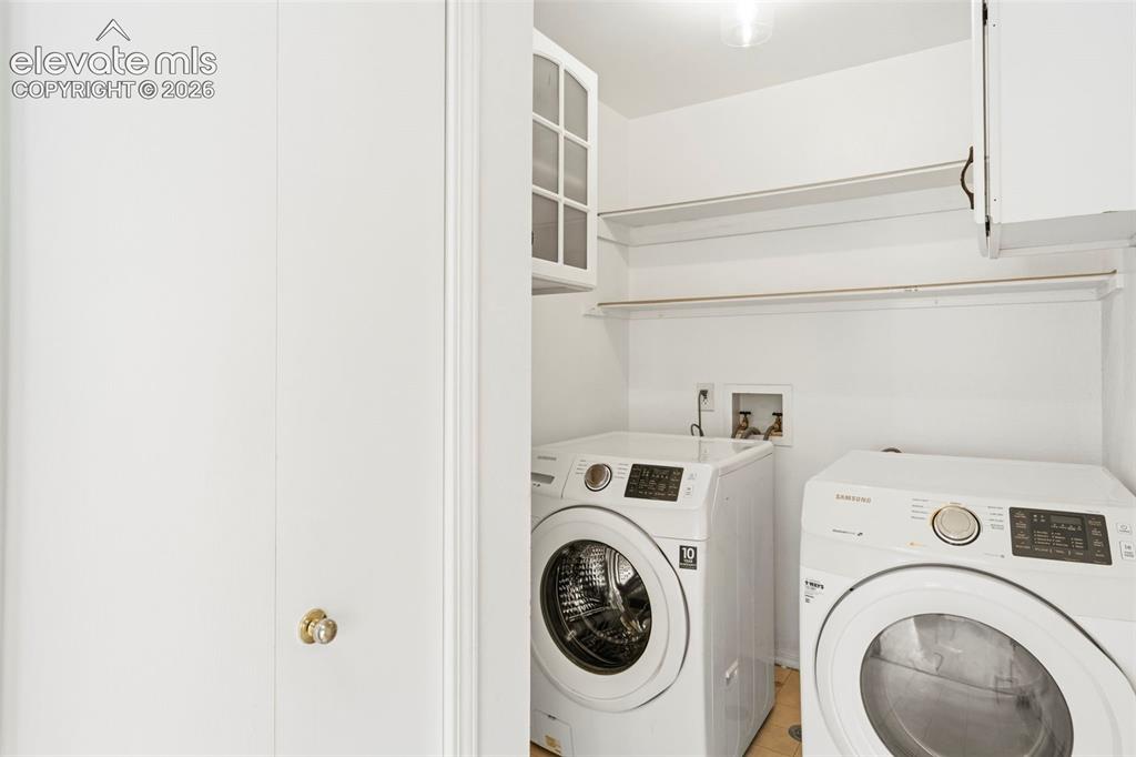 Image 35 of 50: Main level laundry w/ broom closet, cabinets, and garage access. W&D includ