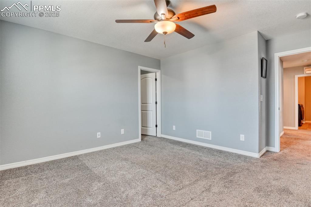 Image 38 of 50: Unfurnished room featuring visible vents, baseboards, carpet, and ceiling f