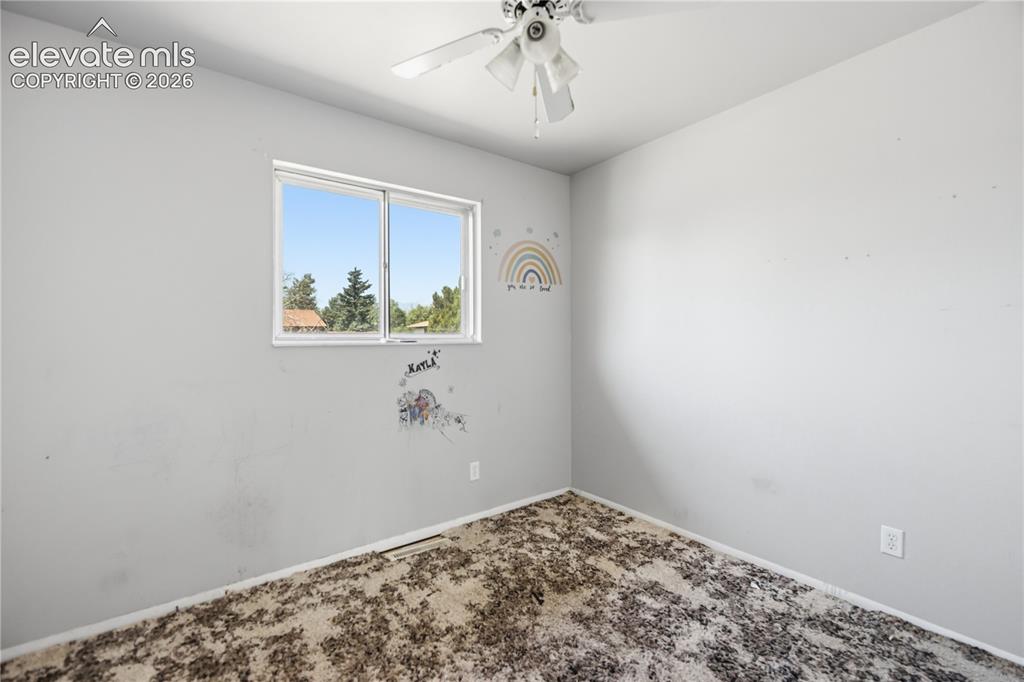 Image 13 of 31: Upper Level Bedroom #3 with lighted ceiling fan.