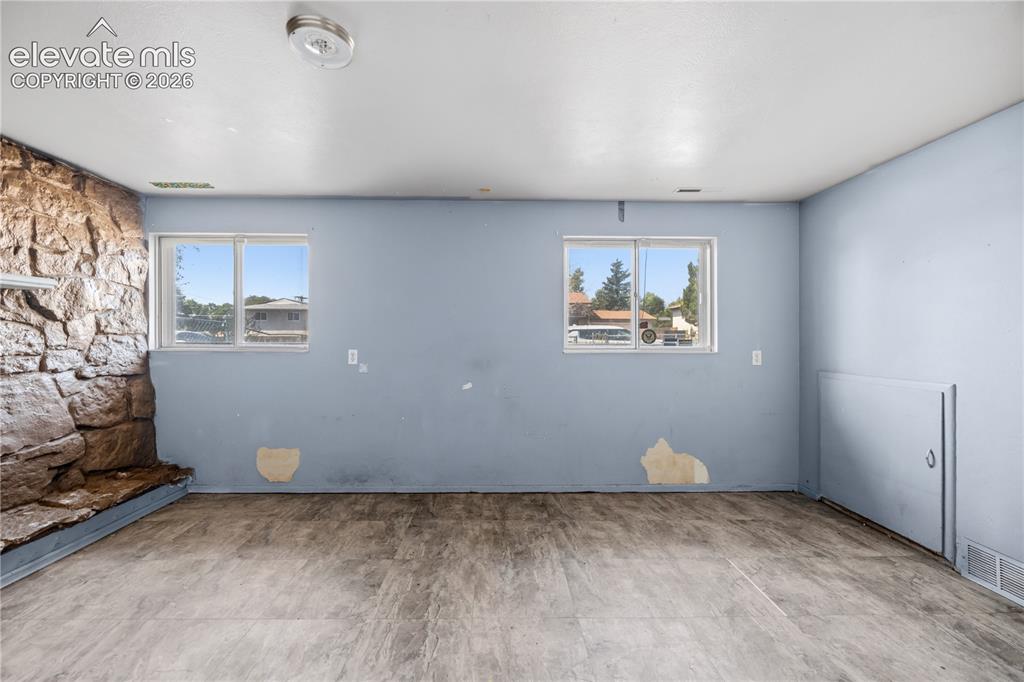 Image 17 of 31: The Lower Level Family Room has wood laminate flooring.