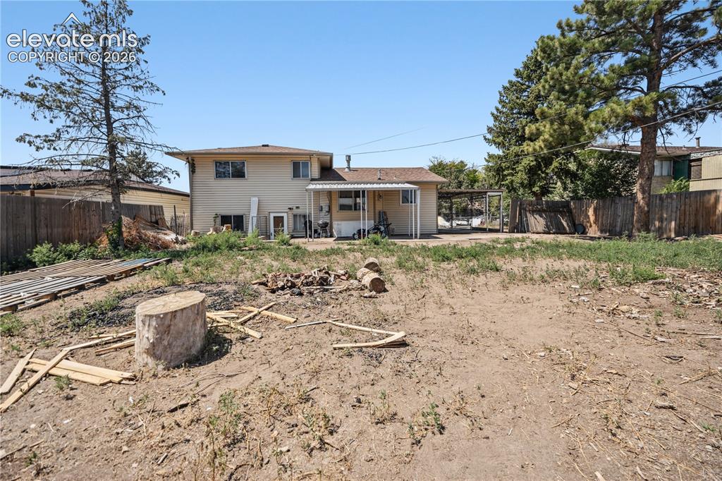 Image 23 of 31: Spacious fenced backyard with lots of potential for your very own backyard