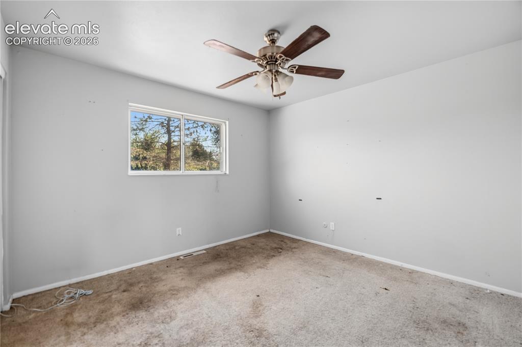Image 9 of 31: Upper Level Primary Bedroom with lighted ceiling fan.