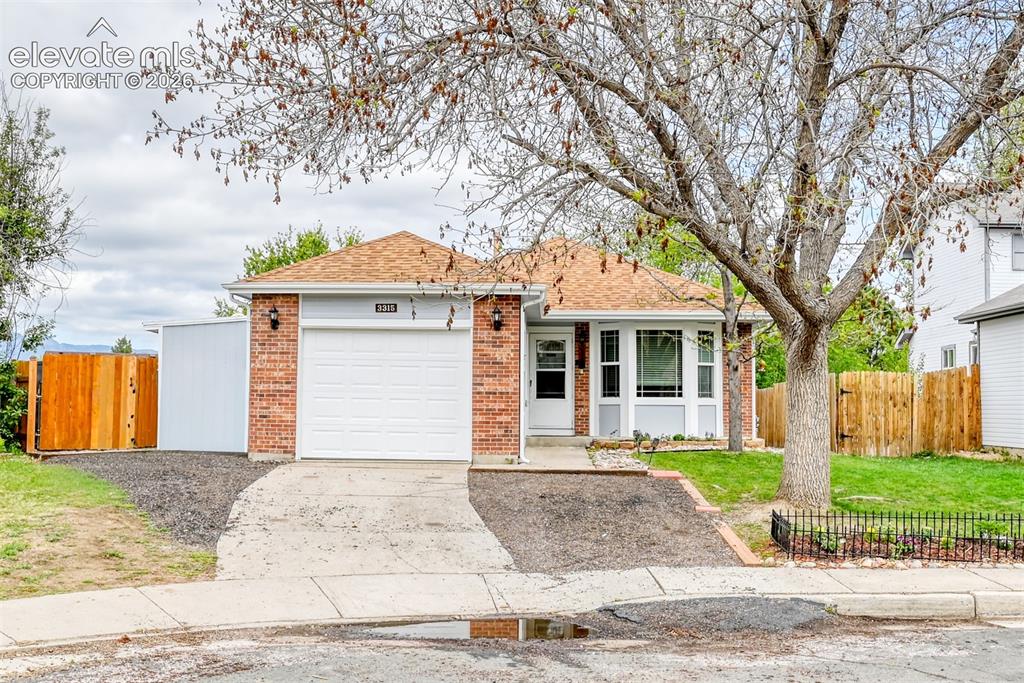 Image 1 of 40: Brick and siding exterior featuring a bay window, attached garage, and a pe