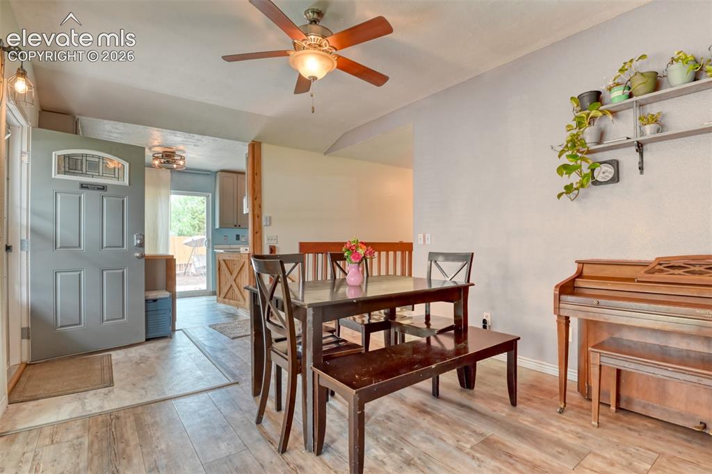 Image 14 of 40: Open concept living area featuring wood-finish flooring and a ceiling fan w