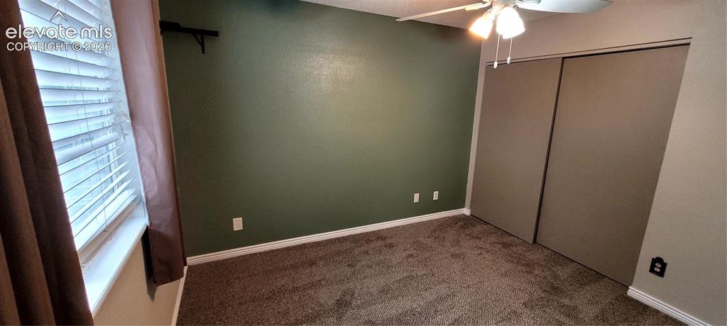 Image 19 of 40: Spacious room featuring plush carpeting, a ceiling fan with integrated ligh
