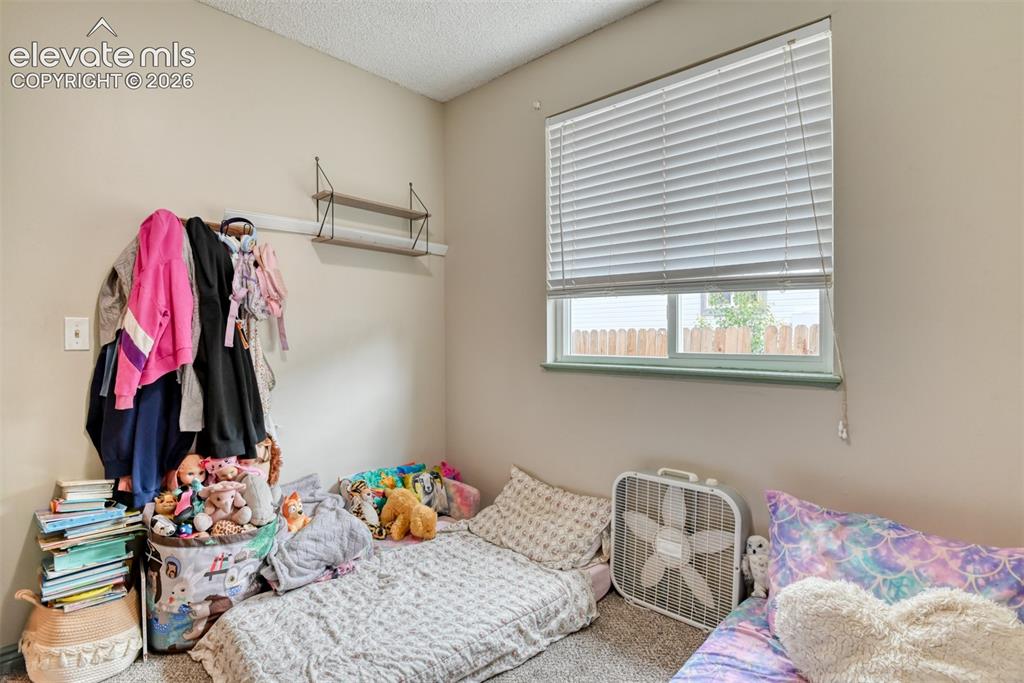 Image 26 of 40: Room featuring light beige walls, a window with white blinds, and a brown w