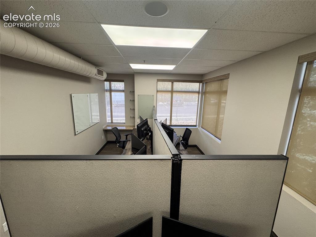 Image 10 of 17: Recessed ceiling lighting, exposed spiral ductwork, built-in desk surfaces,