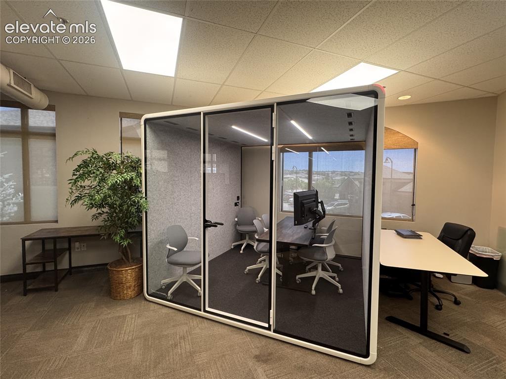 Image 3 of 17: Commercial office space featuring a glass-enclosed meeting room, recessed l