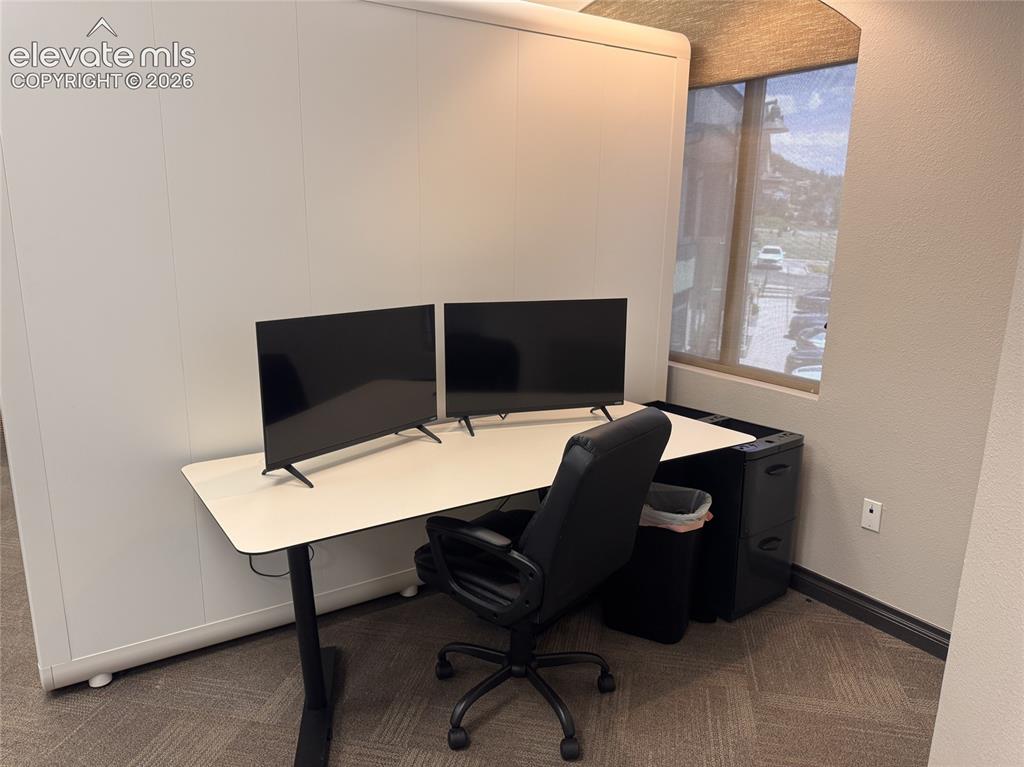 Image 7 of 17: Window with horizontal blinds, textured wall finish, and commercial-grade c