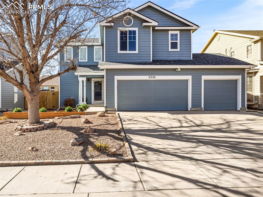 Image 1 of 23: Traditional-style house with concrete driveway, a shingled roof, and an att