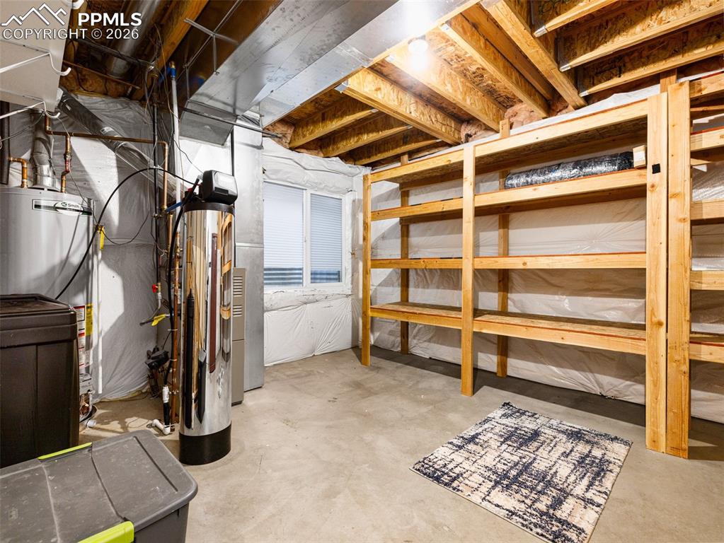 Image 11 of 23: Unfinished basement a water softener, water. heater,furance and lots of sto