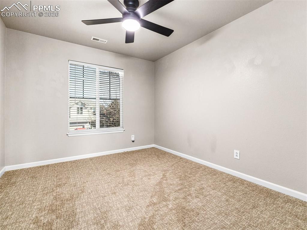 Image 12 of 23: Bedroom 2 with a ceiling fan