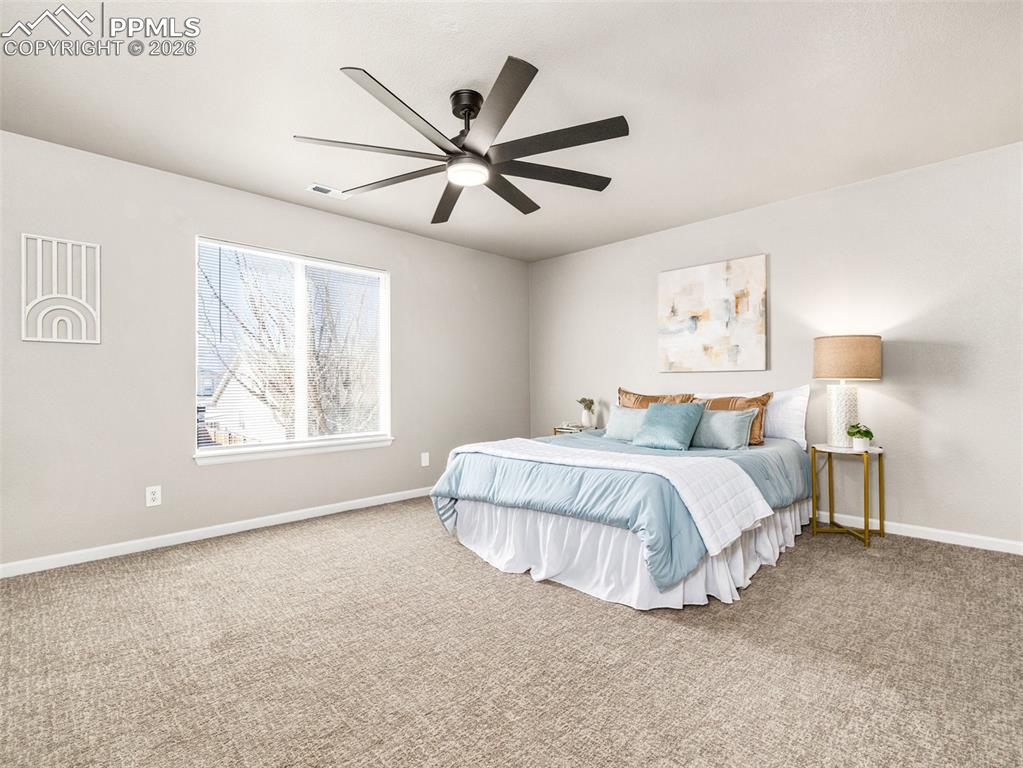 Image 16 of 23: Master bedroom with a ceiling fan
