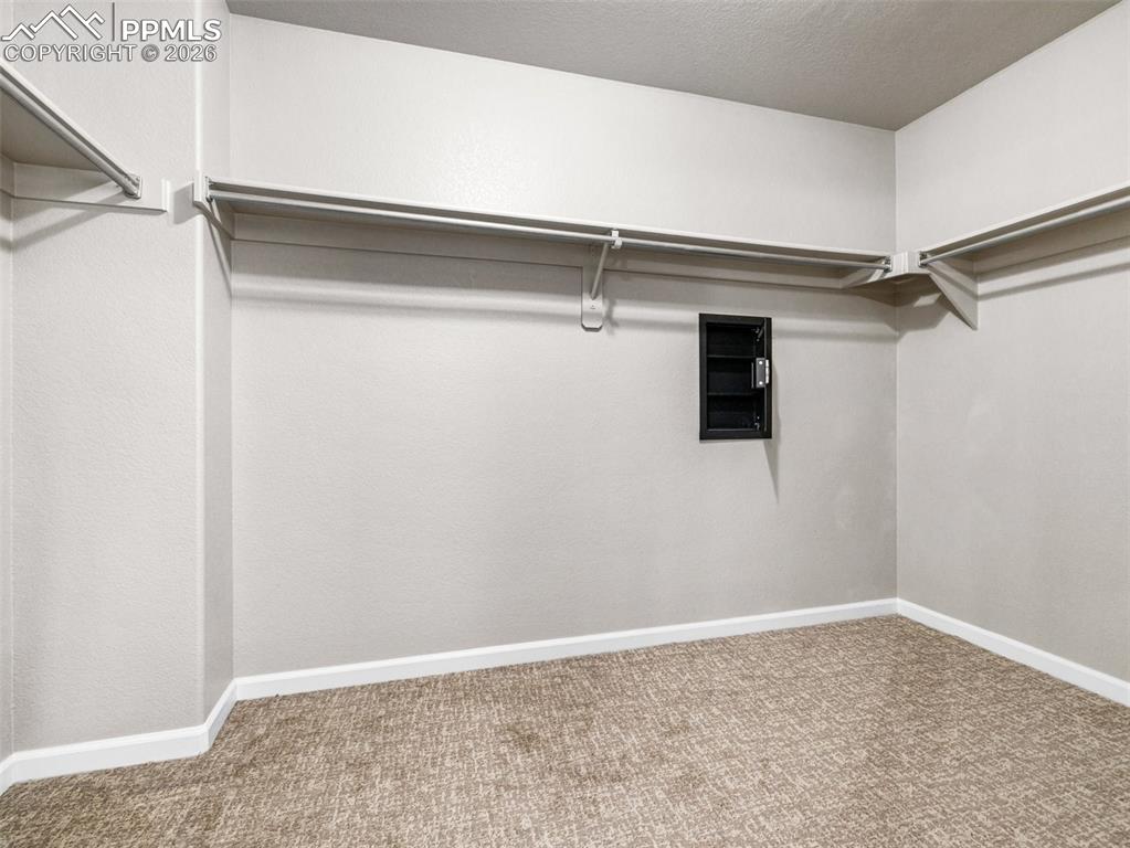 Image 20 of 23: Walk in closet with attached safe