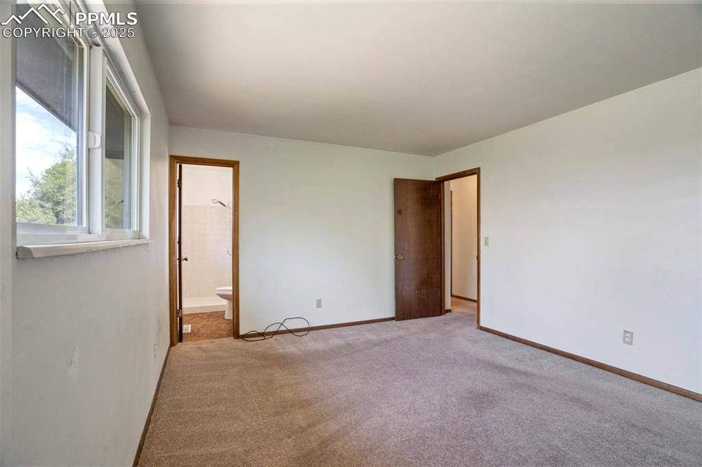 Image 17 of 49: Primary Bedroom with ensuite bathroom