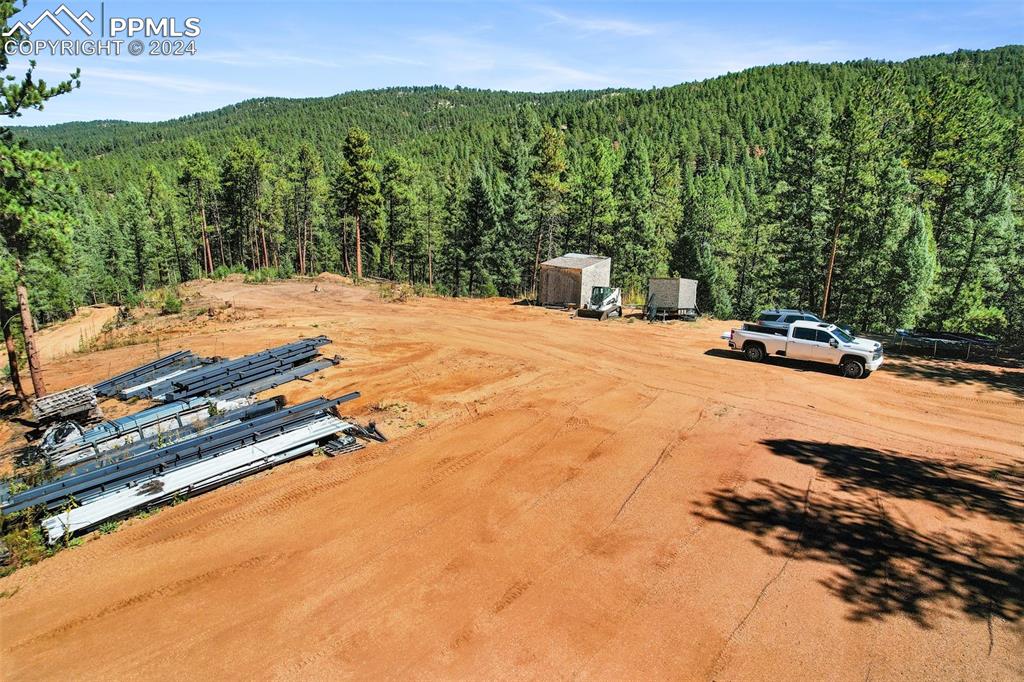 Image 3 of 27: 50x60 steel building pad in foreground; plans included