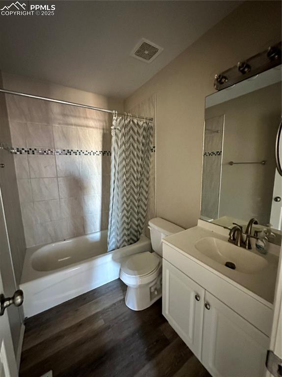 Image 10 of 16: Full bathroom featuring vanity, shower / bath combo with shower curtain, an