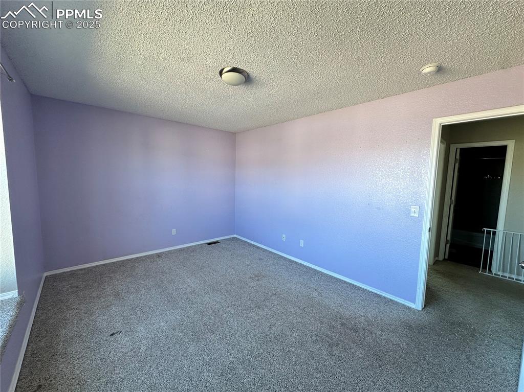 Image 7 of 16: Spare room featuring carpet floors and a textured ceiling