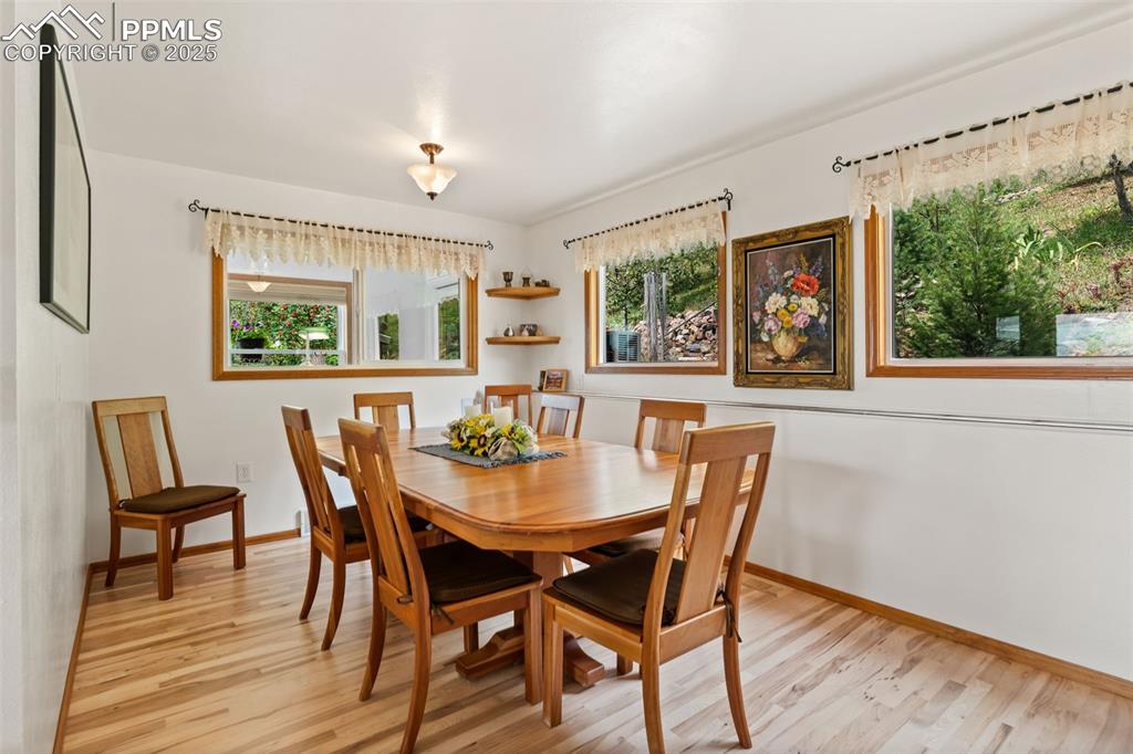 Image 19 of 45: Formal Dinning Room with Large Picture Windows offering Amazing Mountain Vi